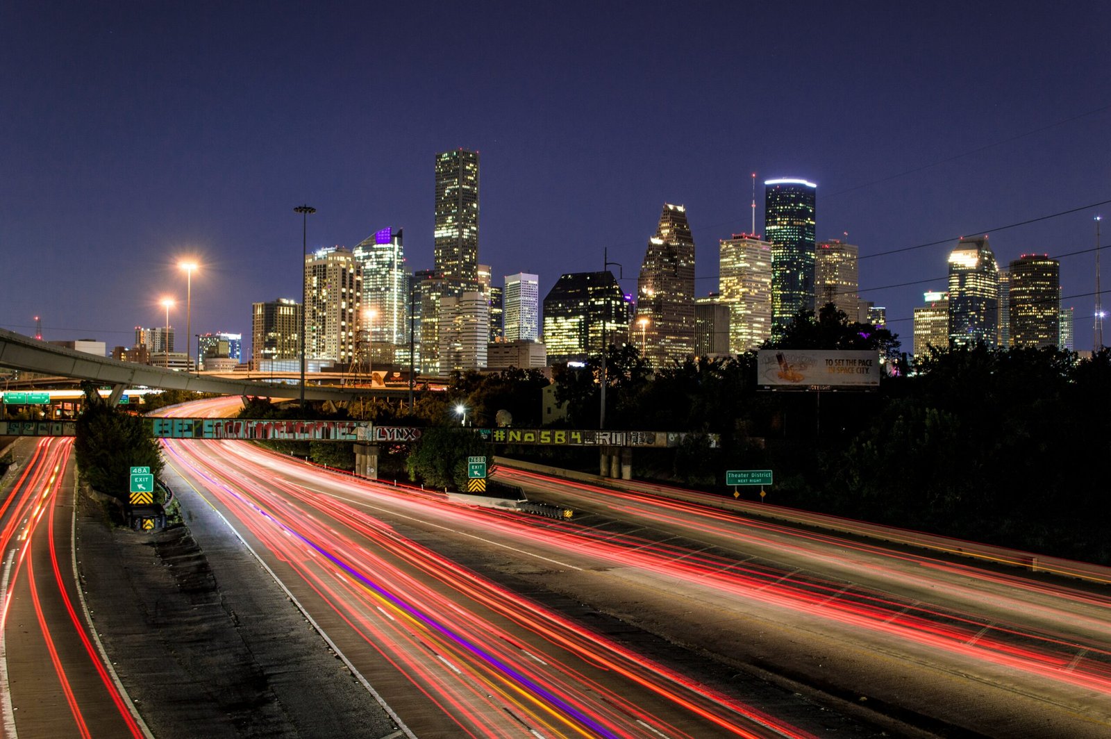 time lapse photography of vehicle traveling with a speed of light in road